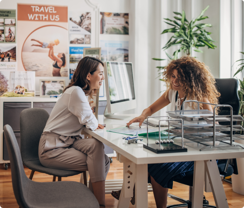 Two women talking at a travel agency.