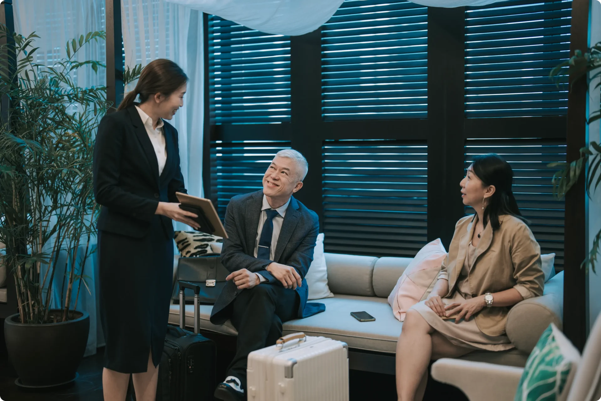 Business travelers conversing in hotel lobby.