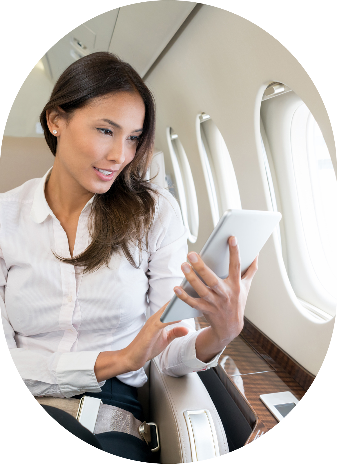 Woman using tablet on airplane seat.