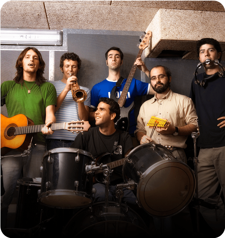 Band members with instruments in a studio.