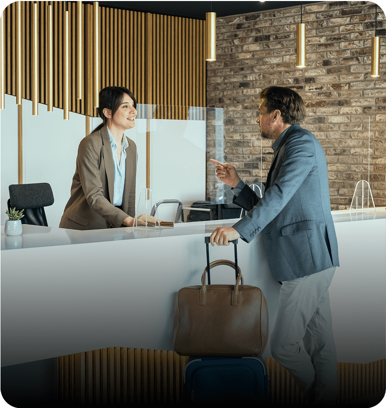 Hotel reception interaction with guest and receptionist.