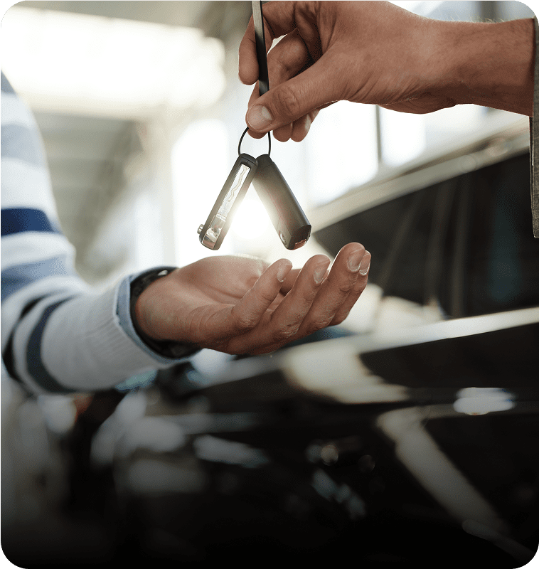 Handing over car keys in dealership.